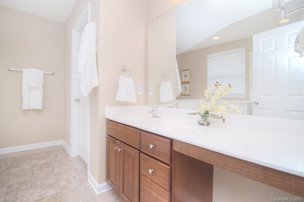 163 Snead Road, Unit 163 Fort Mill, SC 29715 - Photo 14 of 24 a bathroom with a granite countertop sink and a mirror