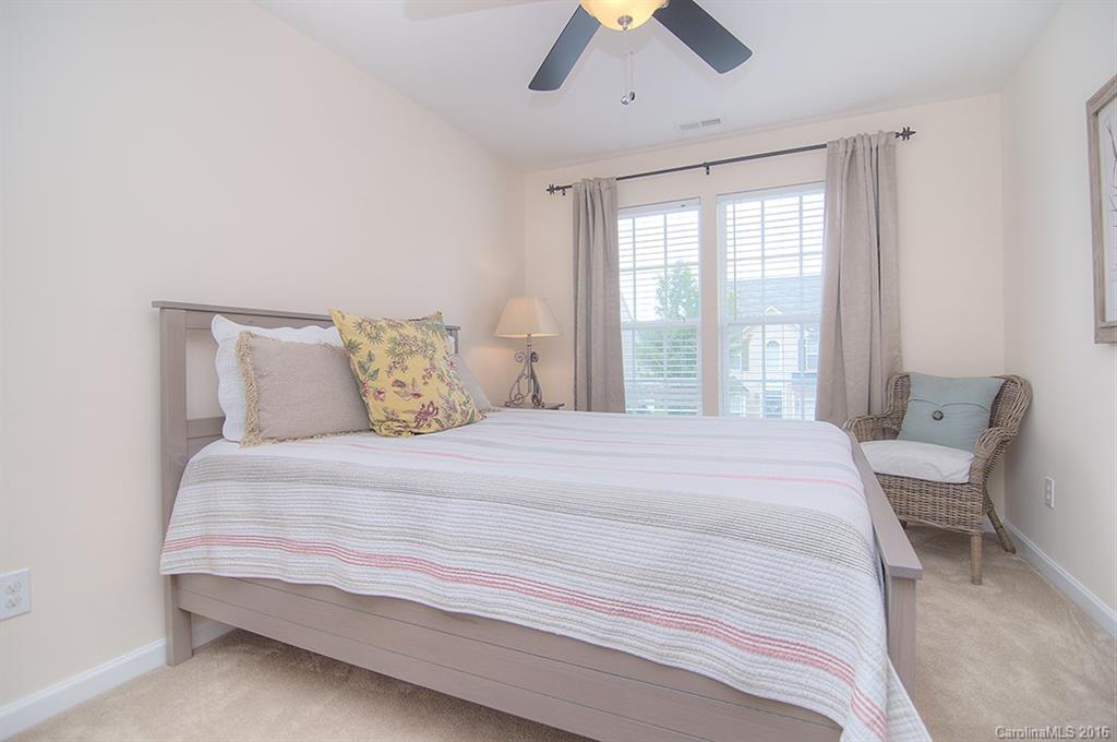 163 Snead Road, Unit 163 Fort Mill, SC 29715 - Photo 19 of 24 a large bed sitting in a bedroom next to a window