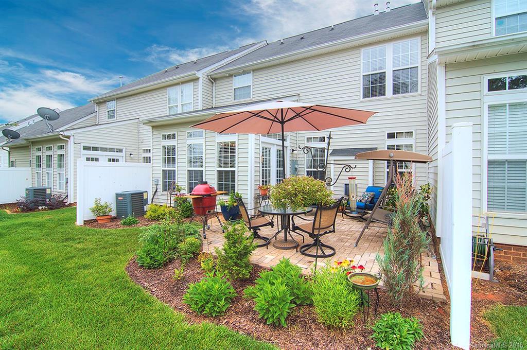 163 Snead Road, Unit 163 Fort Mill, SC 29715 - Photo 23 of 24 a view of a patio with table and chairs under an umbrella