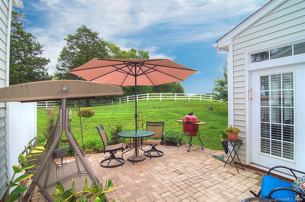163 Snead Road, Unit 163 Fort Mill, SC 29715 - Photo 24 of 24 a view of a patio with chairs and table under an umbrella