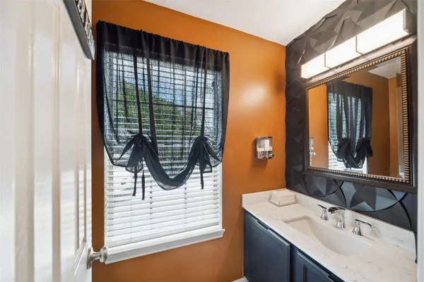 a bedroom with a bed couch and chandelier
