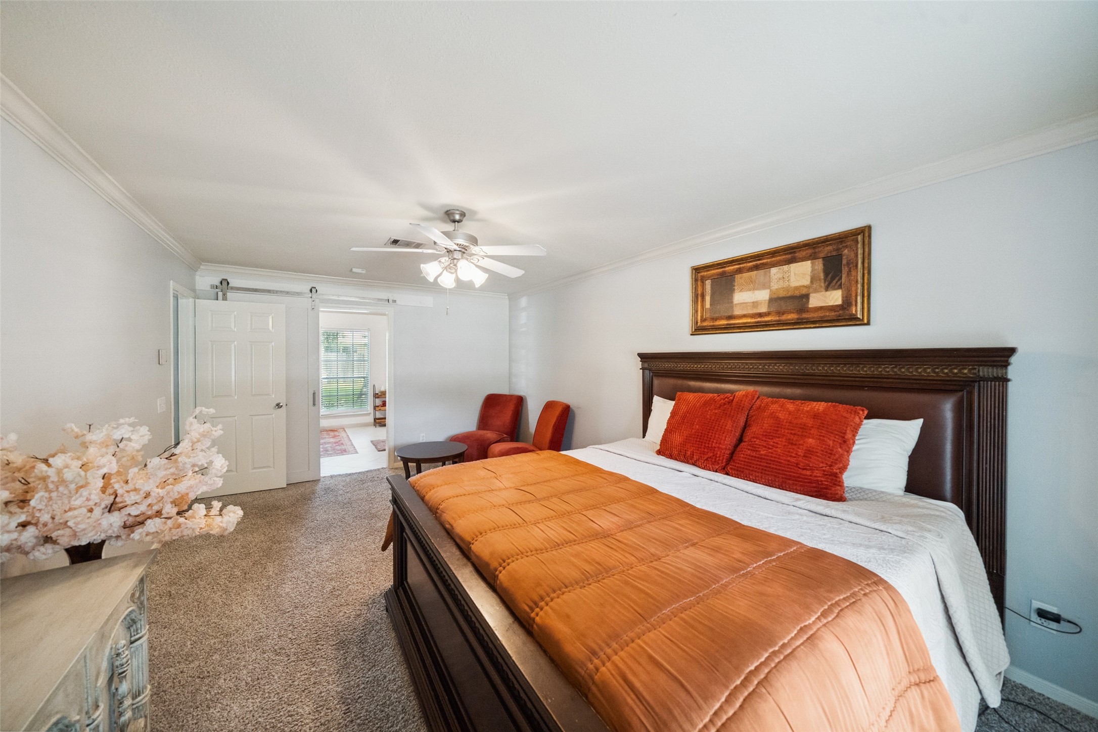 20407 Weald Way Street Spring, TX 77388 - Photo 17 of 31 a bedroom with a large bed and a chandelier