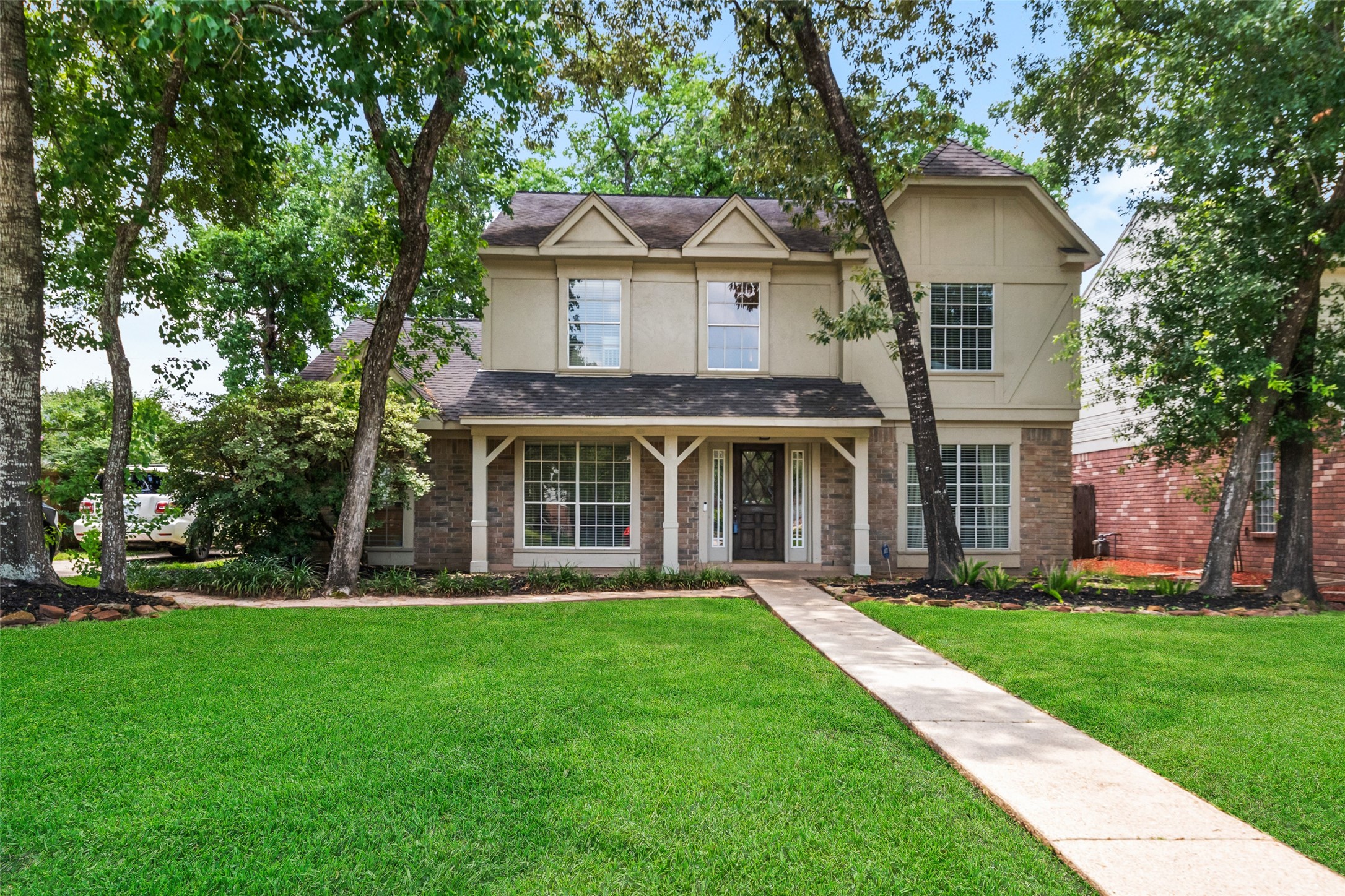 20407 Weald Way Street Spring, TX 77388 - Photo 2 of 31 a front view of a house with a yard and trees