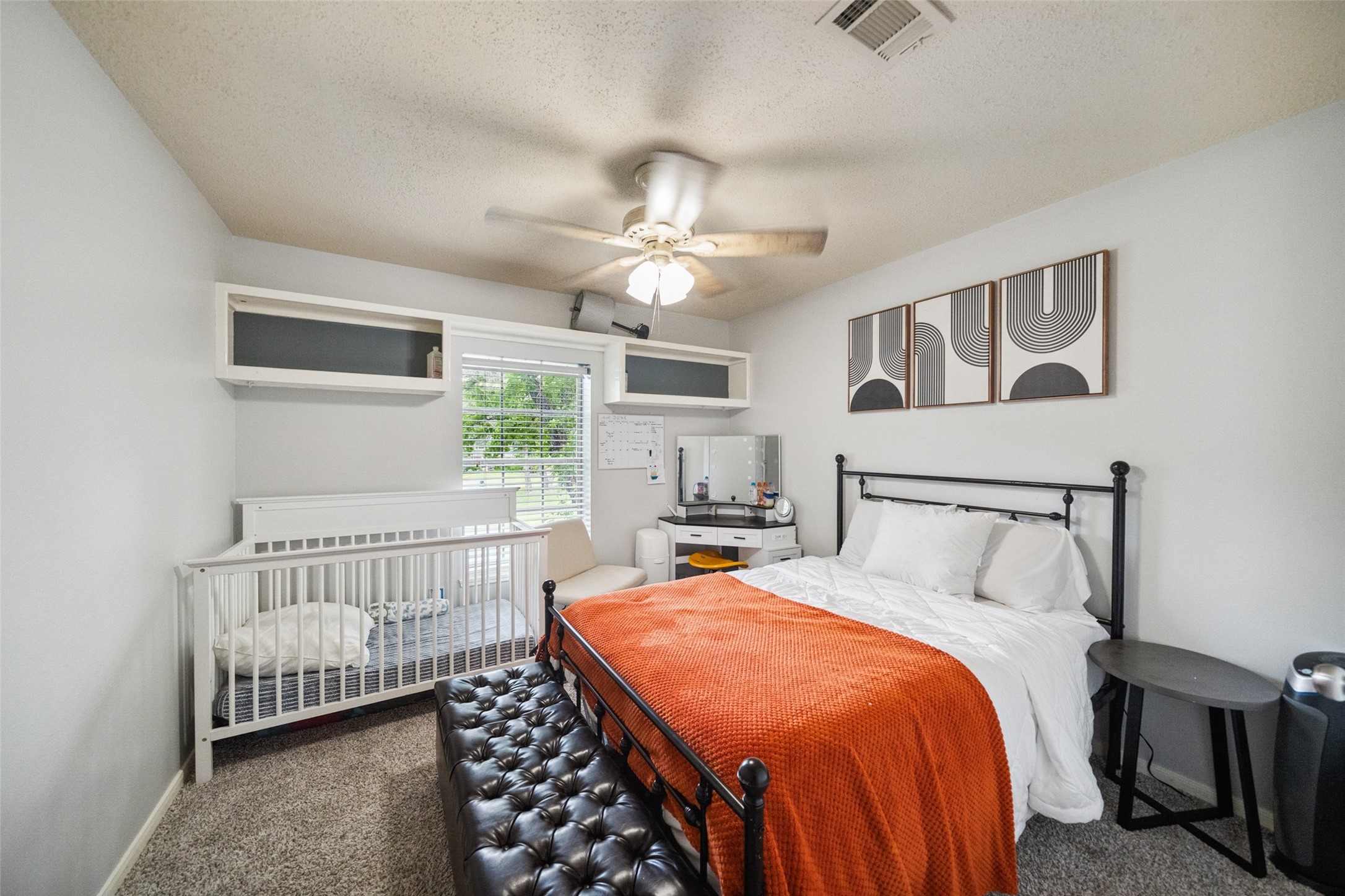 20407 Weald Way Street Spring, TX 77388 - Photo 24 of 31 a bedroom with a bed and a chandelier