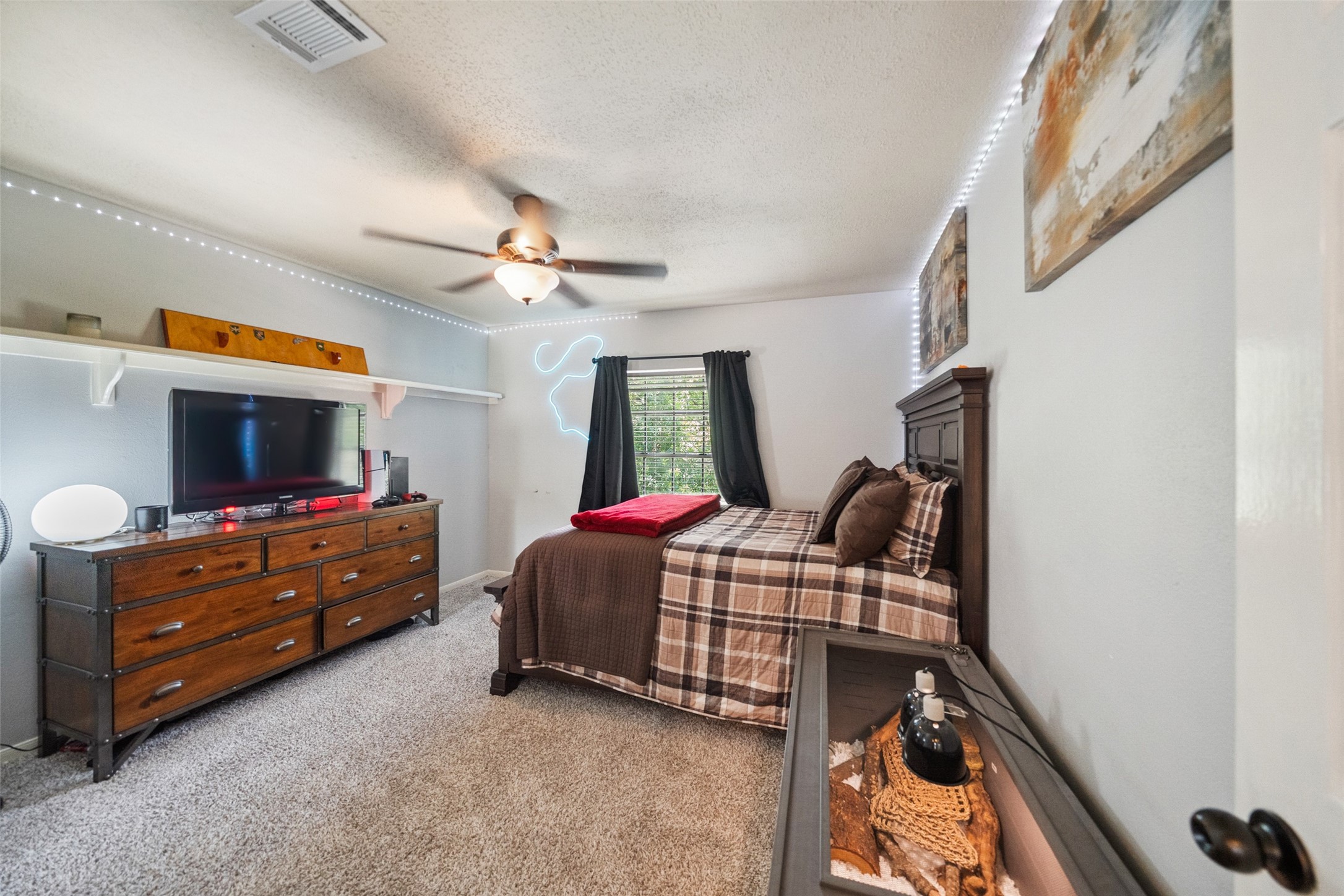 20407 Weald Way Street Spring, TX 77388 - Photo 25 of 31 a bedroom with furniture and a flat screen tv