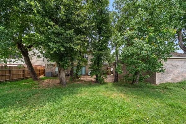 a view of backyard of house with trees