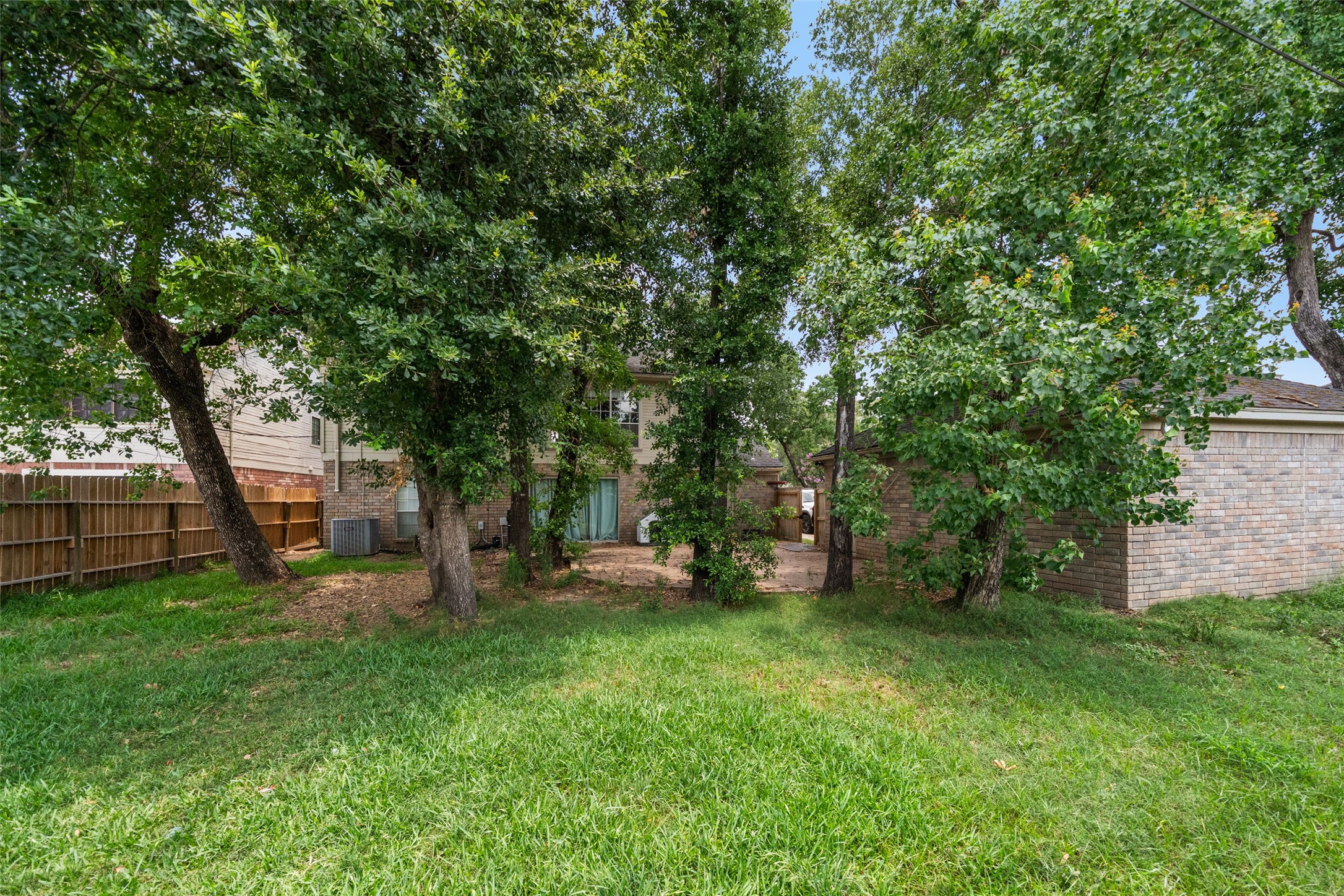 20407 Weald Way Street Spring, TX 77388 - Photo 28 of 31 a view of a backyard with a garden and trees