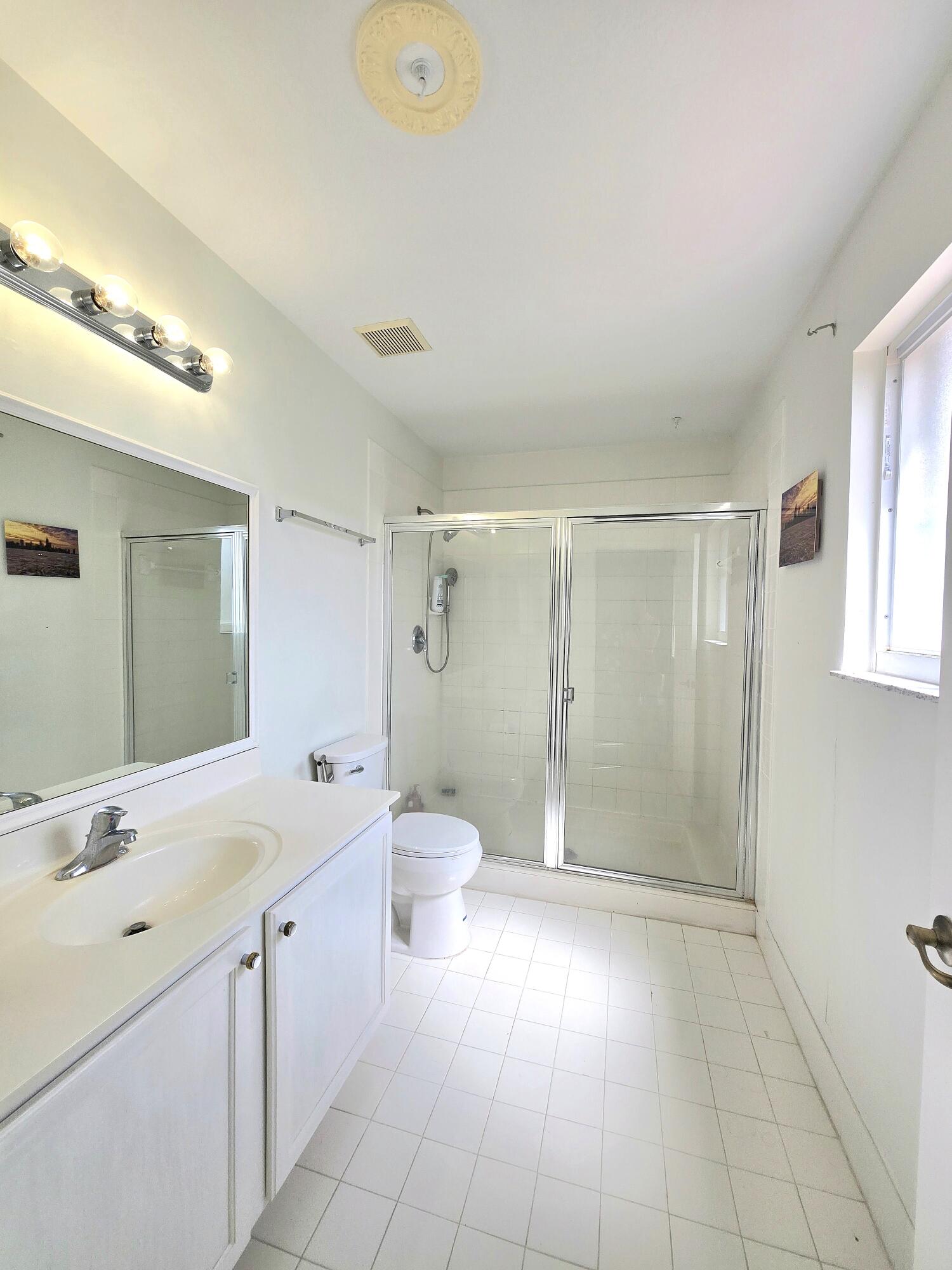 8018 Big Pine Way Riviera Beach, FL 33407 - Photo 7 of 9 a bathroom with a sink a toilet and shower