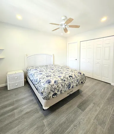 a bedroom with a bed and painting on the wall