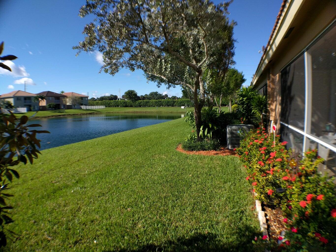 8018 Big Pine Way Riviera Beach, FL 33407 - Photo 9 of 9 a view of a lake with a park