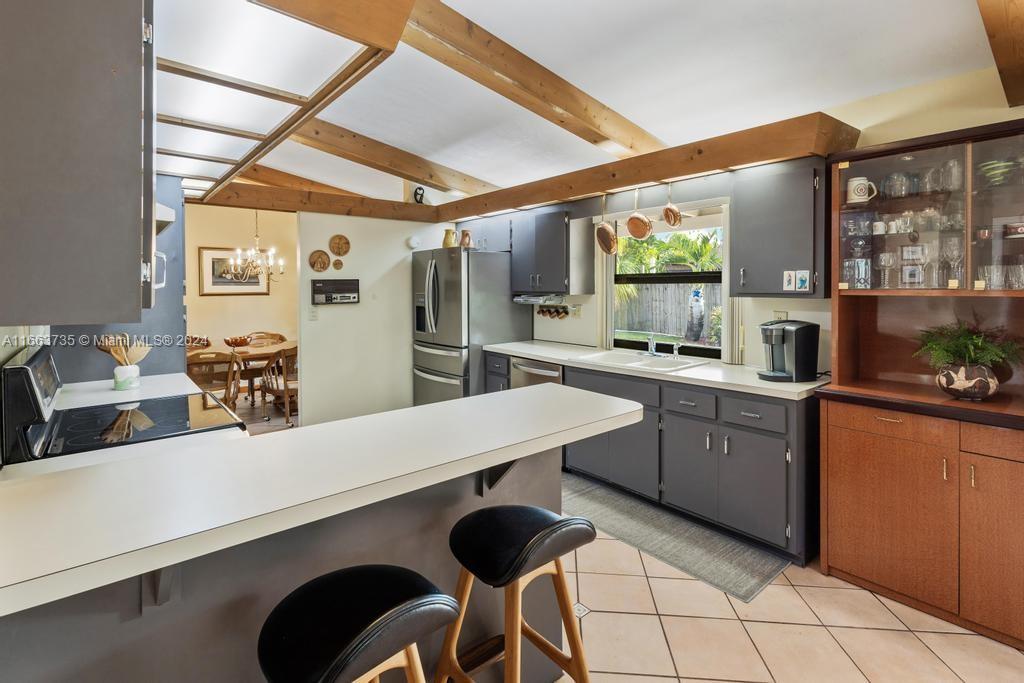 The Hammocks Miami, FL 33186 - Photo 11 of 62 a kitchen with stainless steel appliances kitchen island granite countertop a table chairs in it and wooden floors