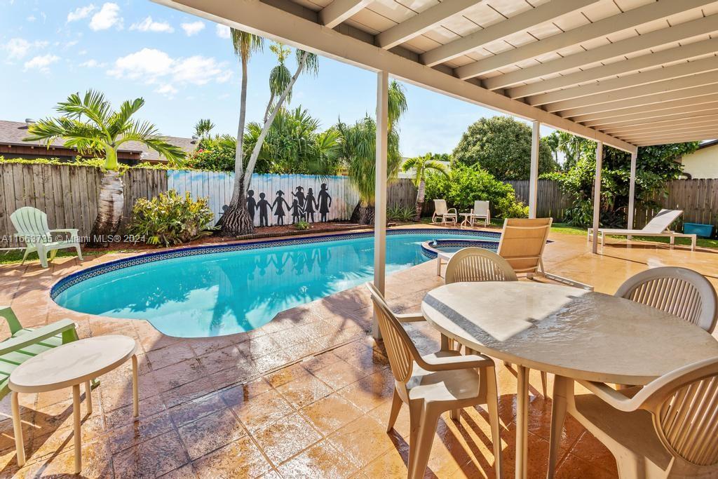 The Hammocks Miami, FL 33186 - Photo 44 of 62 a view of a patio with table and chairs potted plants and floor to ceiling window