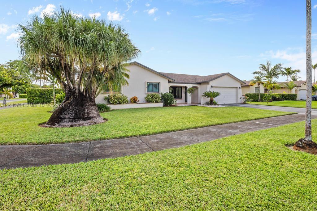 The Hammocks Miami, FL 33186 - Photo 48 of 62 a front view of a house with a garden and trees