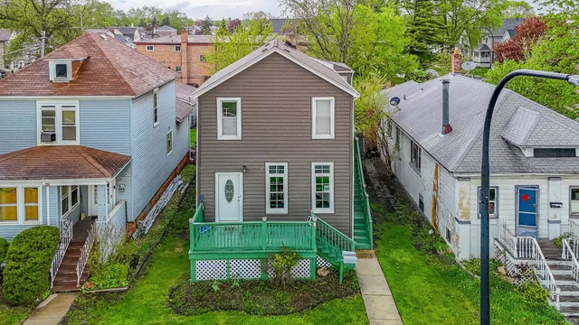 a front view of a house with yard and green space
