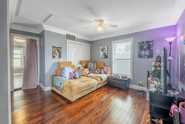 a bedroom with furniture and wooden floor