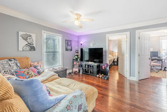 a bedroom with furniture and a flat screen tv