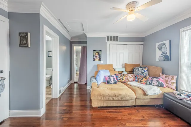 a bedroom with bed and a chandelier