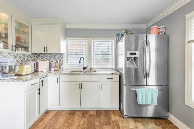 a kitchen with refrigerator and cabinets