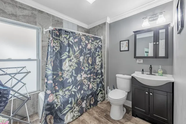 a bathroom with a toilet sink and shower