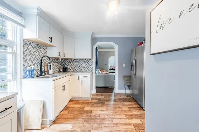 a kitchen with granite countertop a sink and cabinets