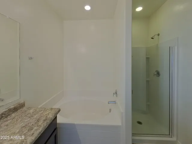 a bathroom with a granite countertop sink and shower