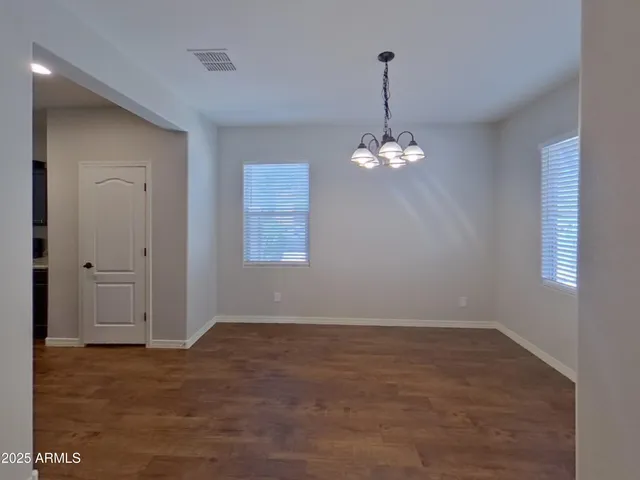 an empty room with windows and entrance