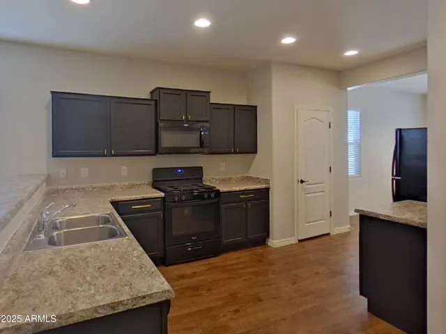 a view of a room with wooden floor and a window
