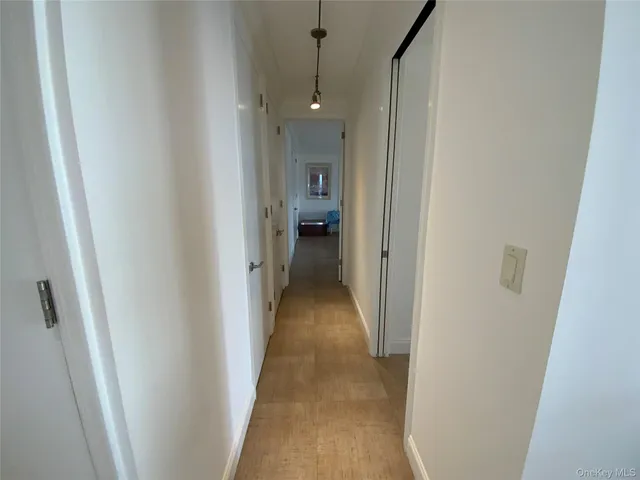 a view of a hallway with a furniture and an entryway