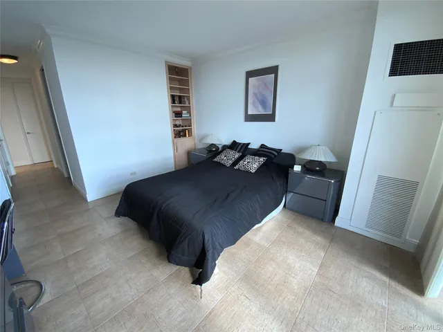 a bedroom with a bed and a rug