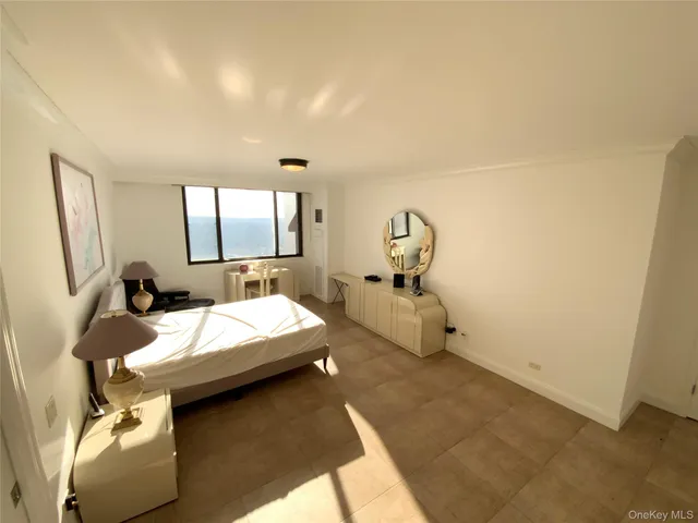 a room with a bed and a dresser