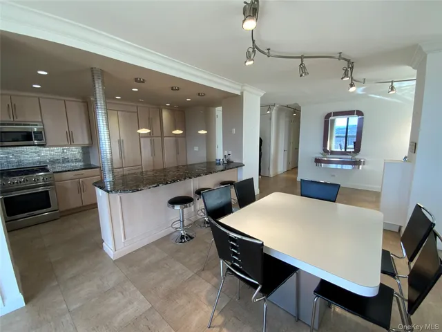 a large kitchen with a table and chairs