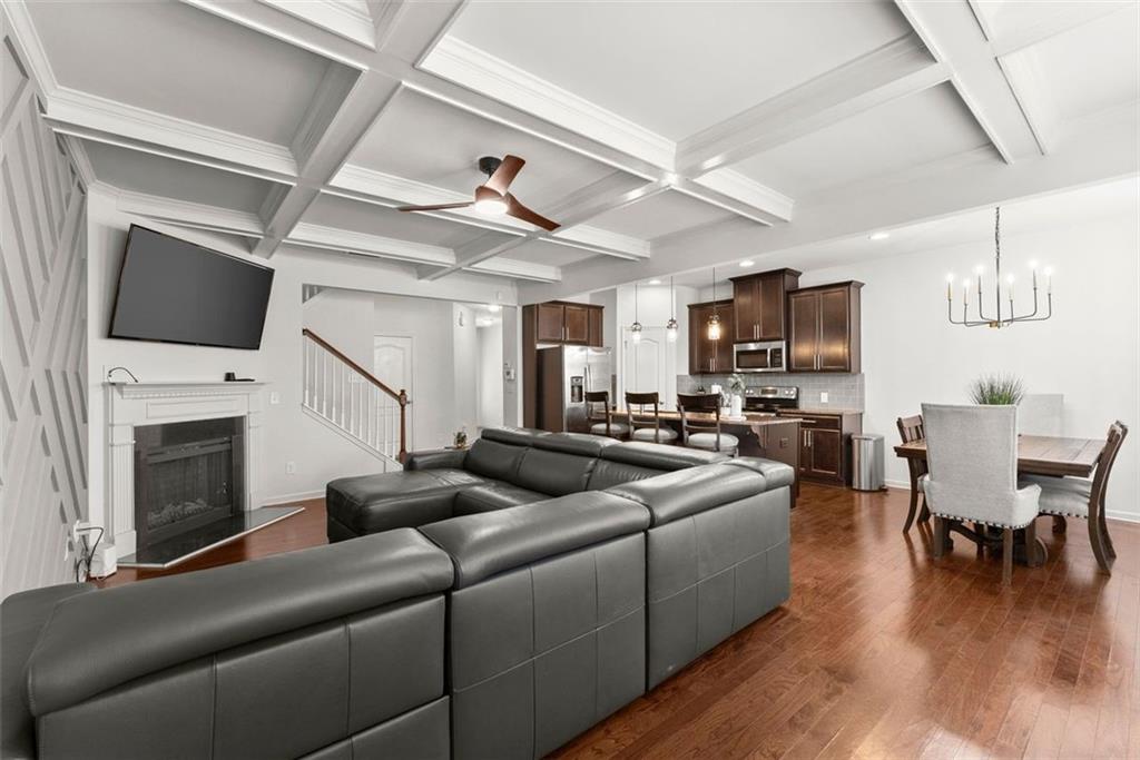 5713 Radford Loop Fairburn, GA 30213 - Photo 11 of 43 a living room with furniture a fireplace and a flat screen tv