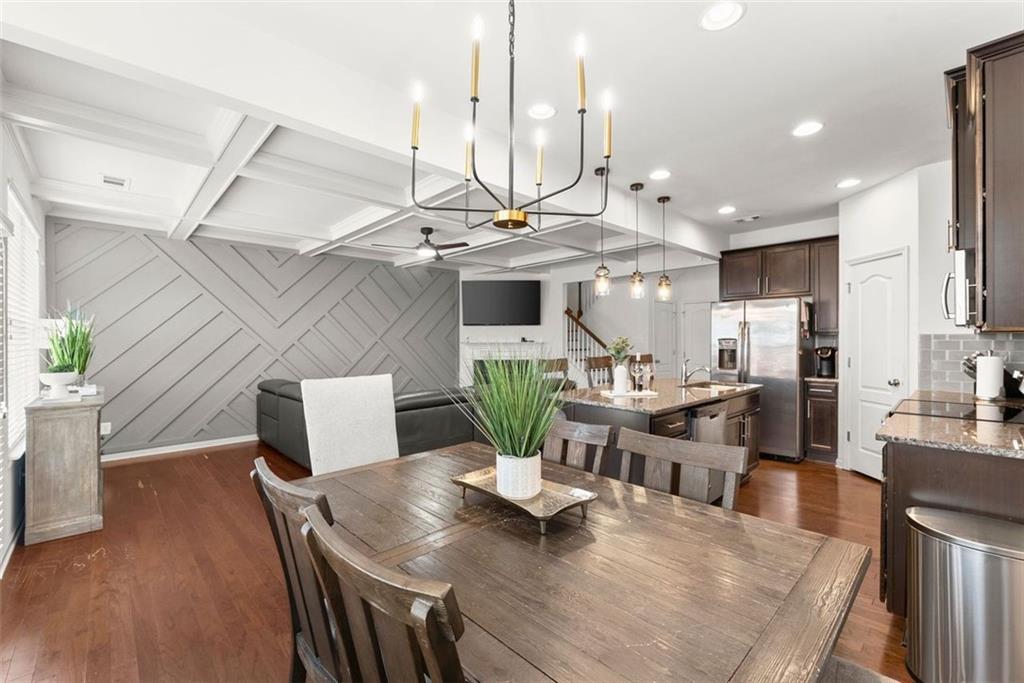 5713 Radford Loop Fairburn, GA 30213 - Photo 15 of 43 a view of a dining room with furniture a rug and wooden floor