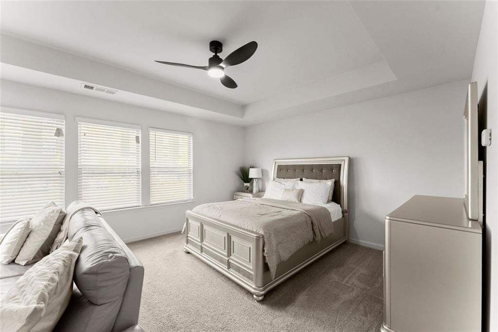 5713 Radford Loop Fairburn, GA 30213 - Photo 20 of 43 a bed room with a bed and a couch