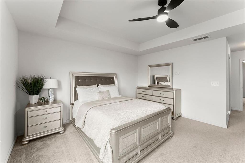 5713 Radford Loop Fairburn, GA 30213 - Photo 21 of 43 a bedroom with a bed and a couch