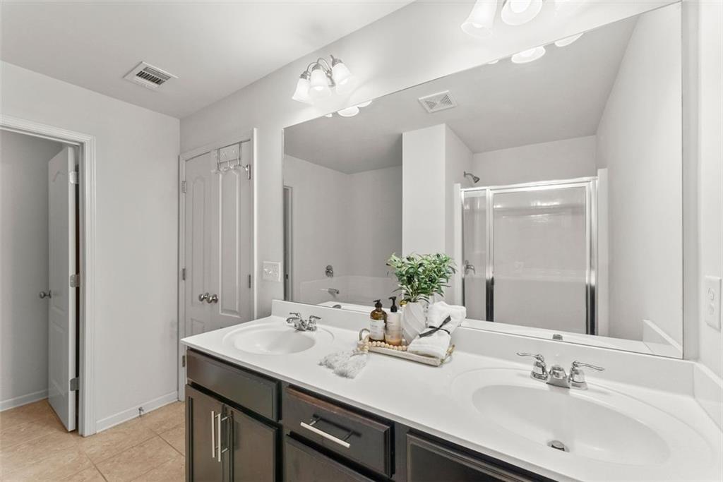 5713 Radford Loop Fairburn, GA 30213 - Photo 23 of 43 a bathroom with a sink double vanity and a mirror