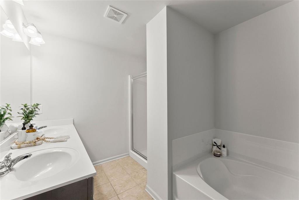 5713 Radford Loop Fairburn, GA 30213 - Photo 24 of 43 a bathroom with a sink and a bathtub