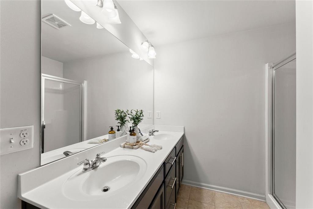 5713 Radford Loop Fairburn, GA 30213 - Photo 26 of 43 a bathroom with a sink and a mirror