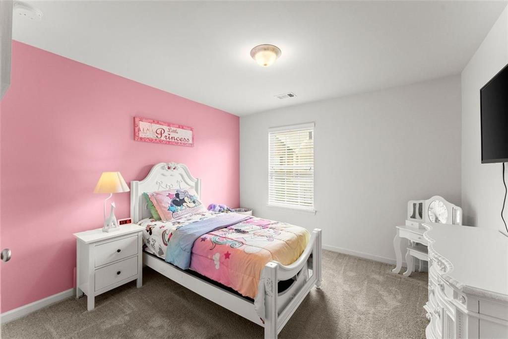 5713 Radford Loop Fairburn, GA 30213 - Photo 29 of 43 a bedroom with a bed and a window