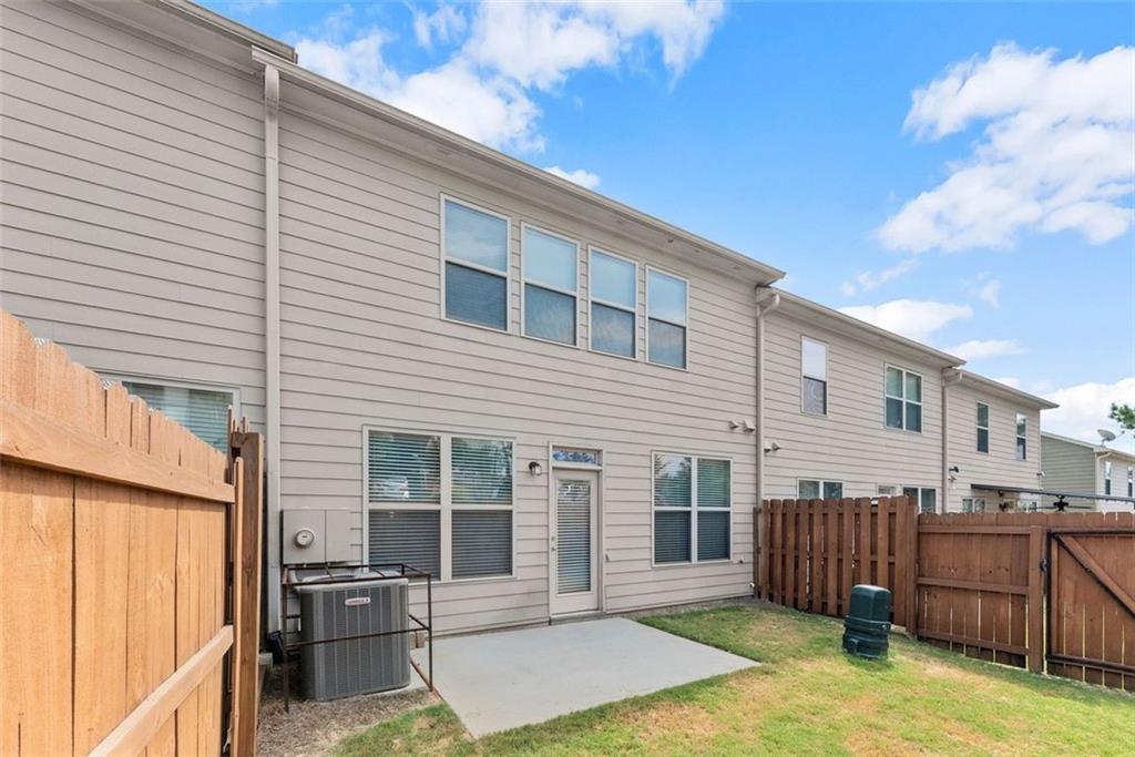 5713 Radford Loop Fairburn, GA 30213 - Photo 34 of 43 a backyard of a house with barbeque oven and outdoor seating