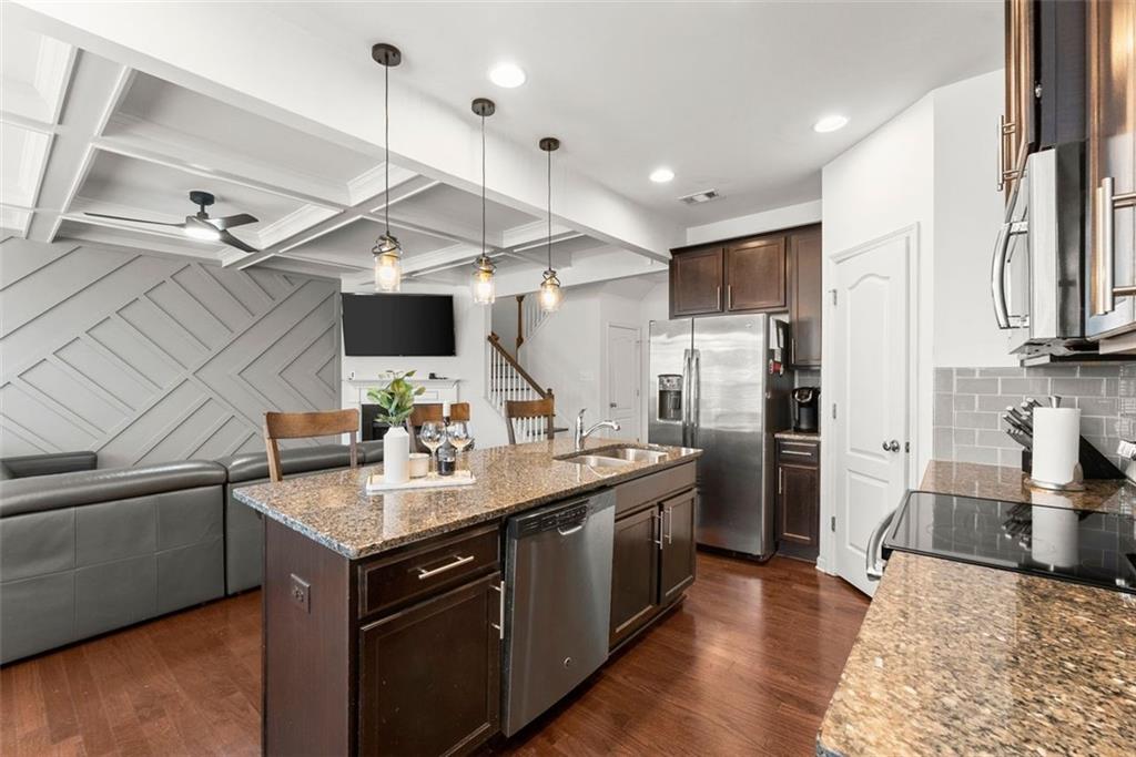 5713 Radford Loop Fairburn, GA 30213 - Photo 4 of 43 a kitchen with stainless steel appliances granite countertop a sink a stove and a refrigerator