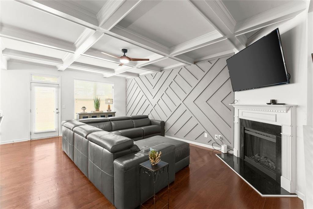 5713 Radford Loop Fairburn, GA 30213 - Photo 9 of 43 a living room with furniture a flat screen tv and a fireplace