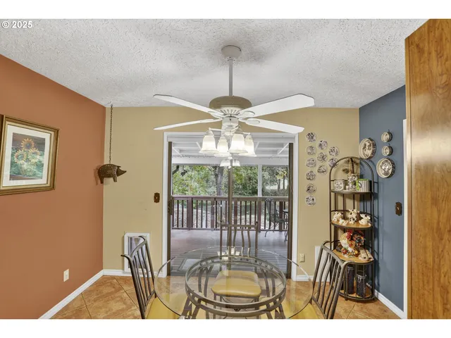 a dining room with furniture a chandelier and window