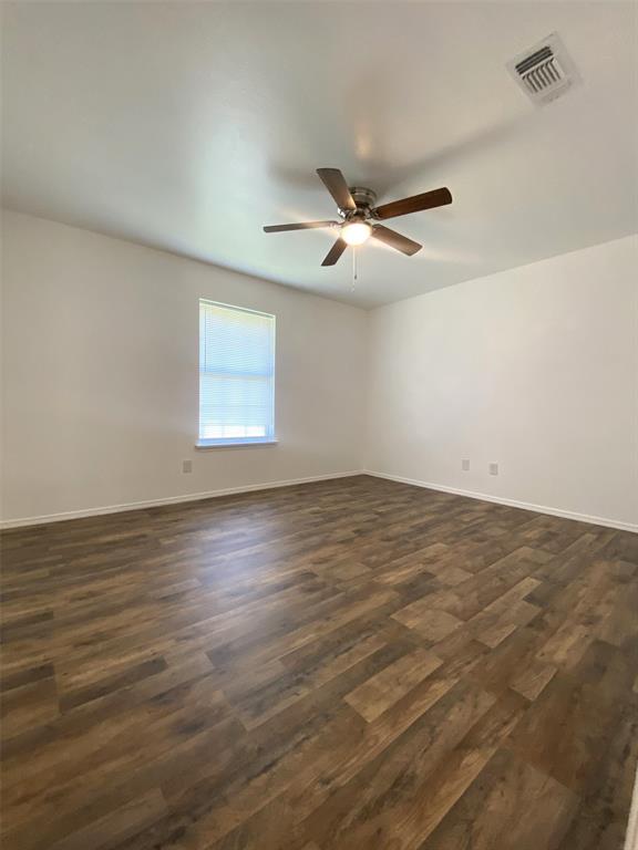 505 Red Springs Avenue Mount Pleasant, TX 75455 - Photo 7 of 9 Spare room featuring dark wood-type flooring and a ceiling fan