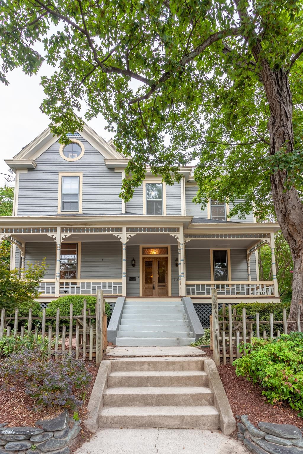 323 Lane Street Raleigh, NC 27601 - Photo 2 of 42 a front view of a house with a garden