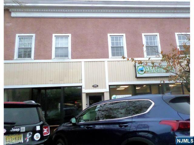 196 Rock Road, Unit 2B Glen Rock, NJ 07452 - Photo 1 of 22 a living room with furniture and a fireplace