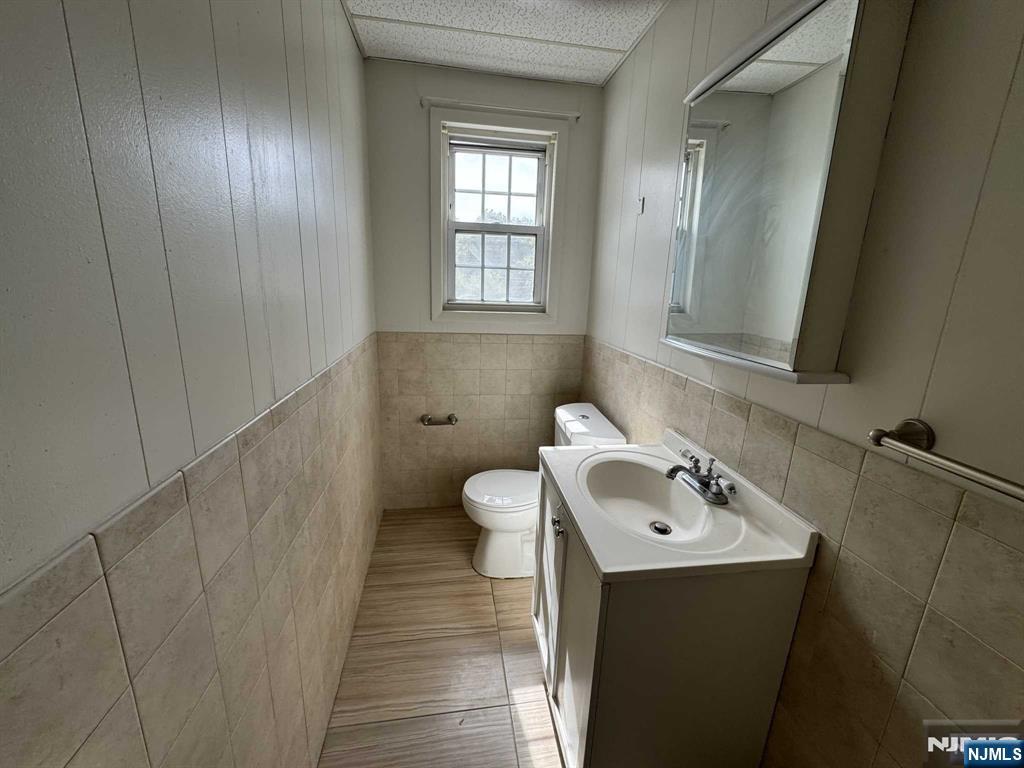 196 Rock Road, Unit 2B Glen Rock, NJ 07452 - Photo 12 of 22 a bathroom with a sink a toilet and mirror