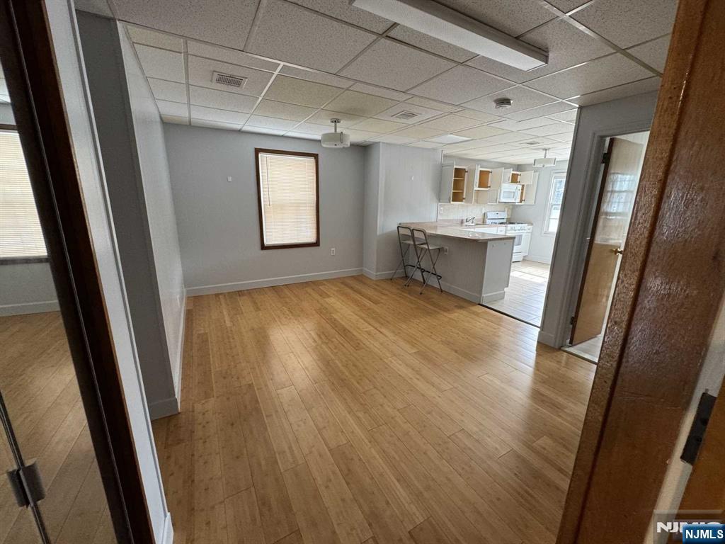 196 Rock Road, Unit 2B Glen Rock, NJ 07452 - Photo 3 of 22 a view of a kitchen with a refrigerator and white cabinets