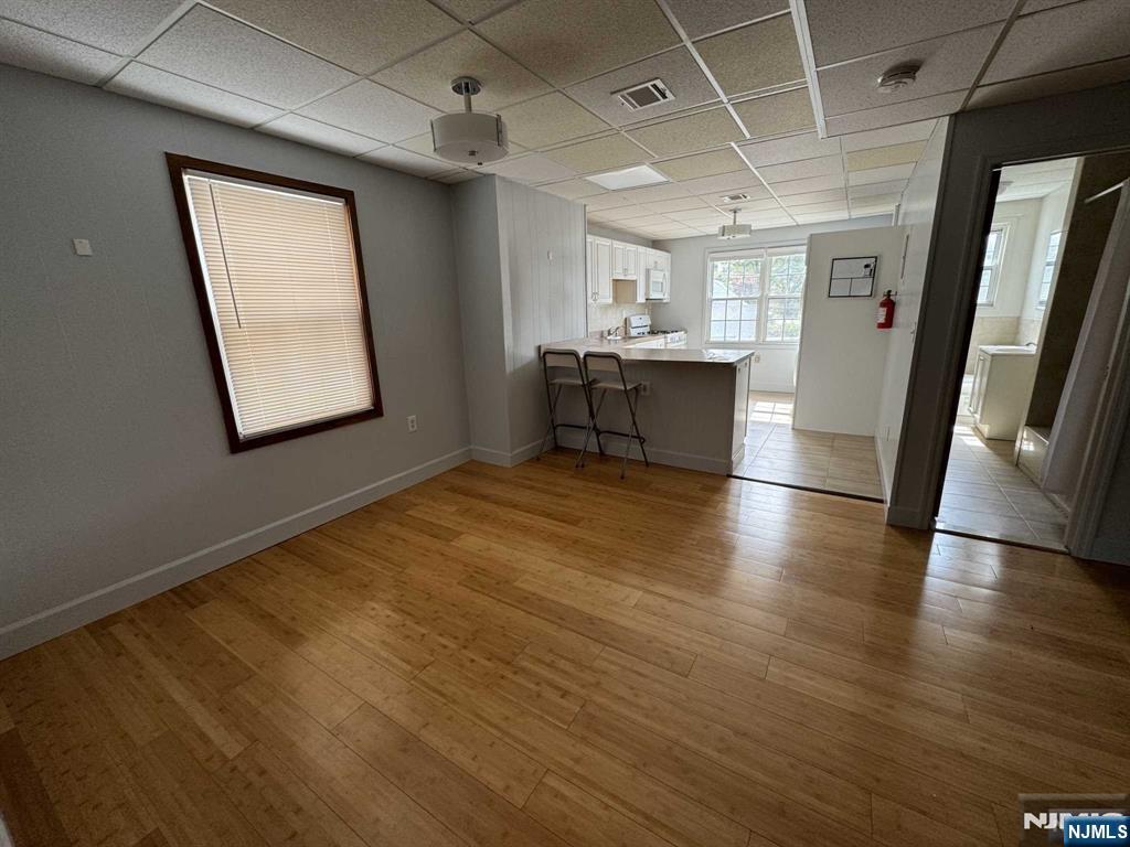 196 Rock Road, Unit 2B Glen Rock, NJ 07452 - Photo 4 of 22 a view of a hallway with wooden floor and a kitchen