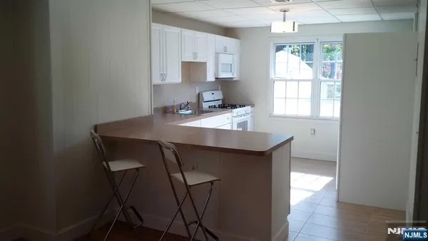 a kitchen with sink cabinets and wooden floor